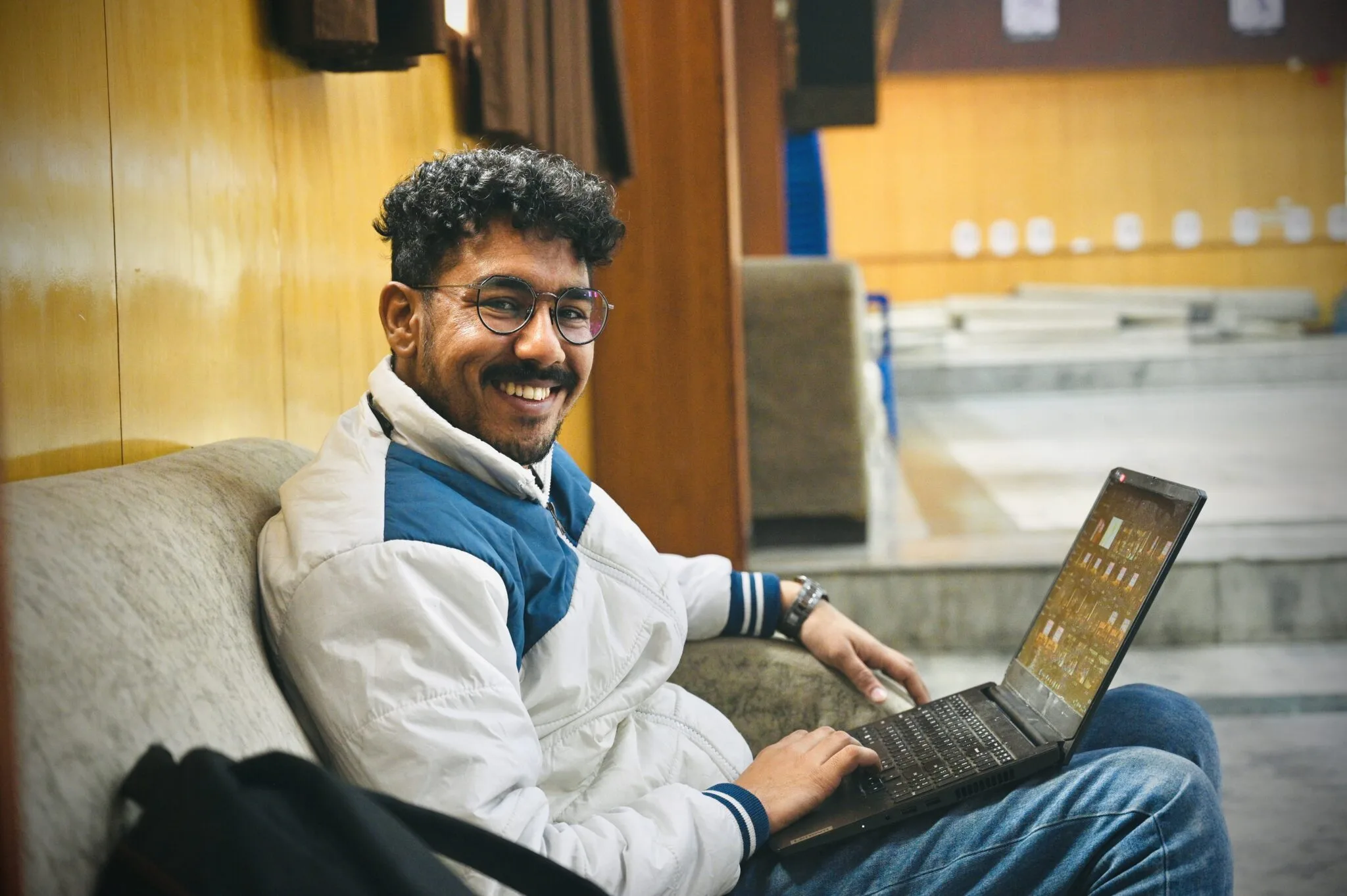 Man sitting on sofa with laptop.