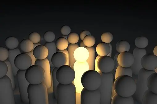 A person stands out in a crowd, drawing attention with their unique presence and distinct appearance.